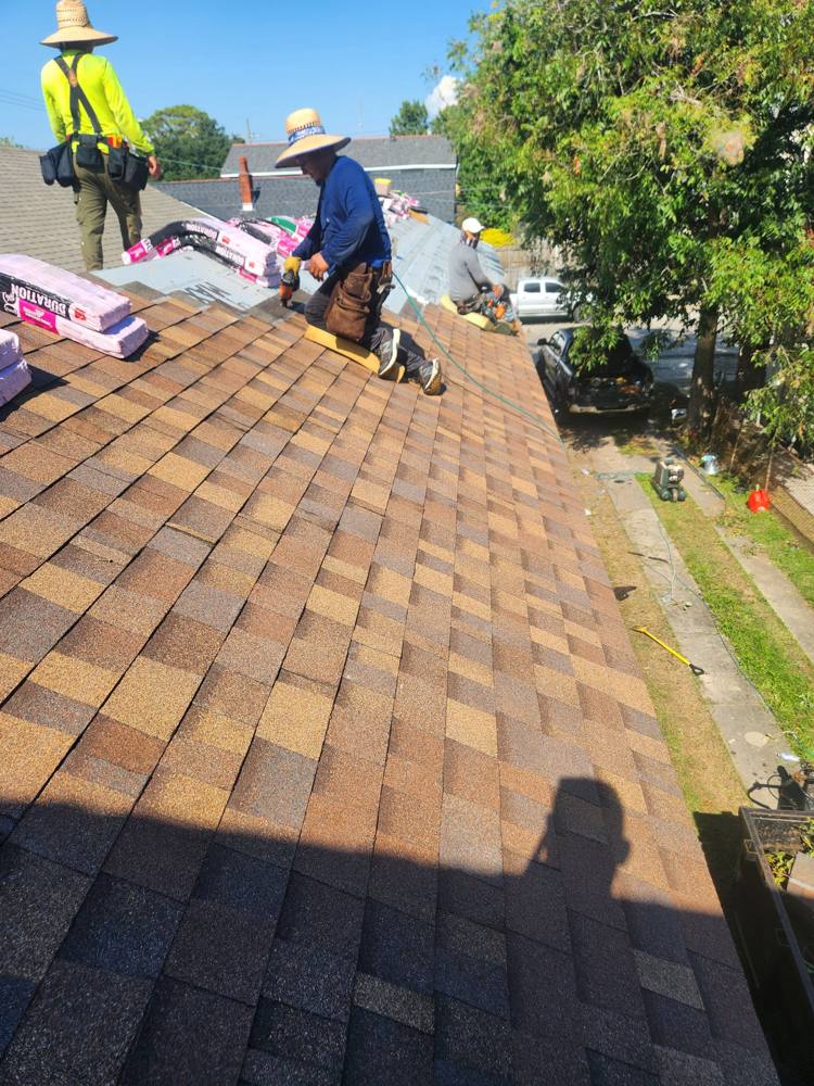 Crew installing architectural shingles on a New Orleans roof