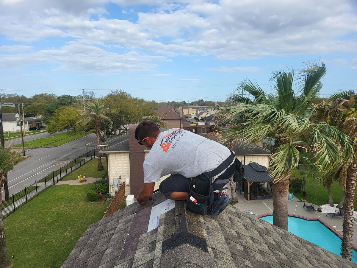 Roofer installing hip and ridge shingles on a New Orleans roof