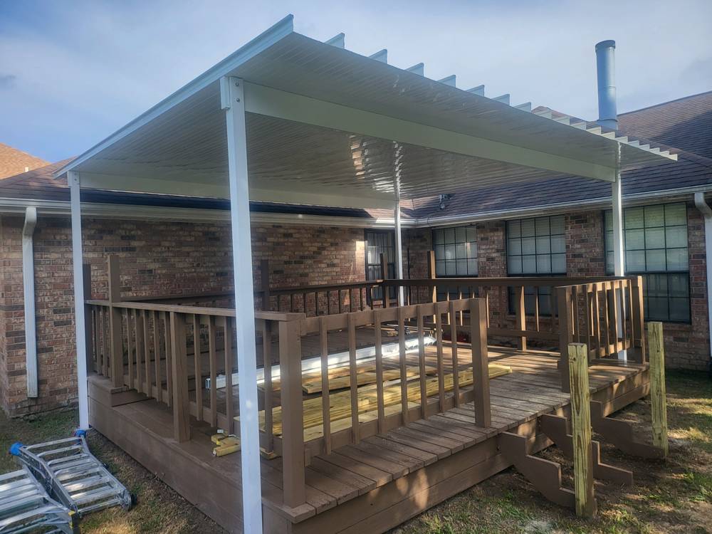 White aluminum patio cover over a wood deck