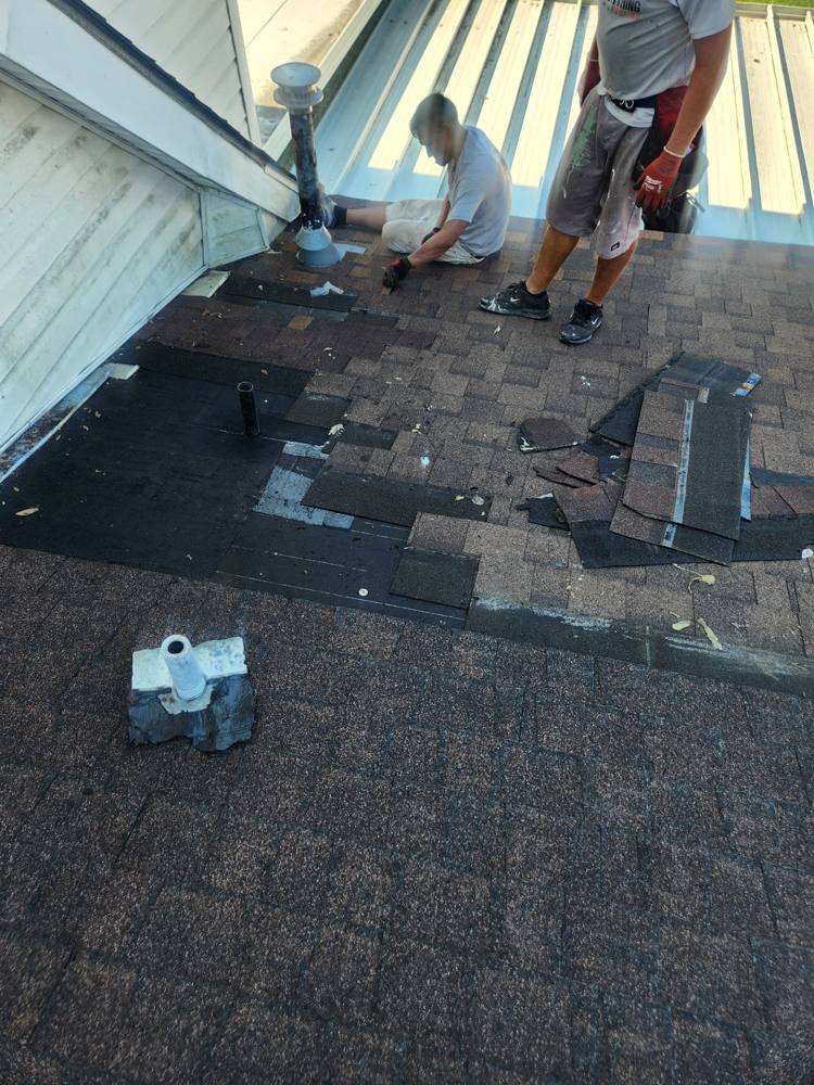 Repairing shingles around a roof vent