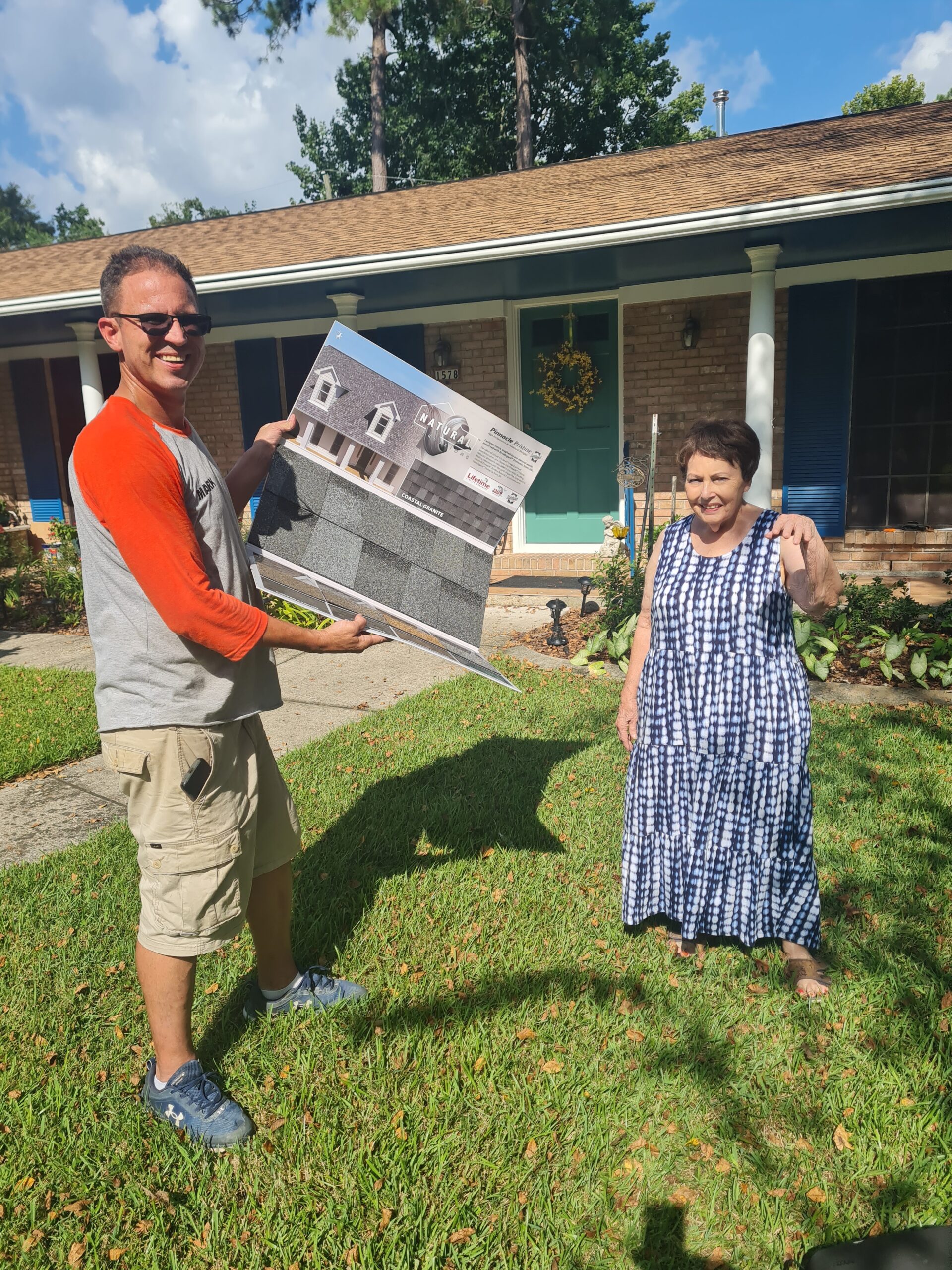 Anything and Everything Owner Mark Curtis displaying shingle sample to customer.